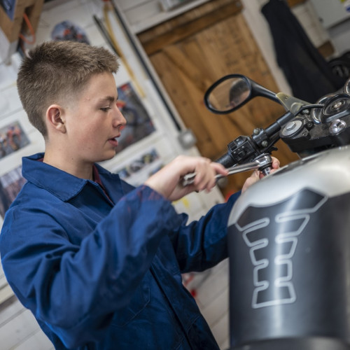Student working on a motorbike